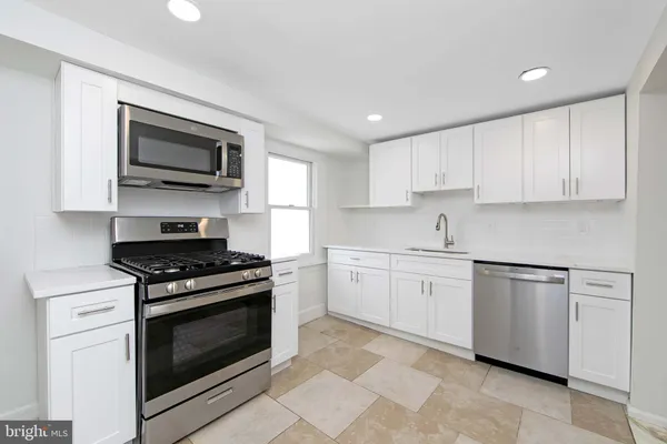 a kitchen with a refrigerator and a sink