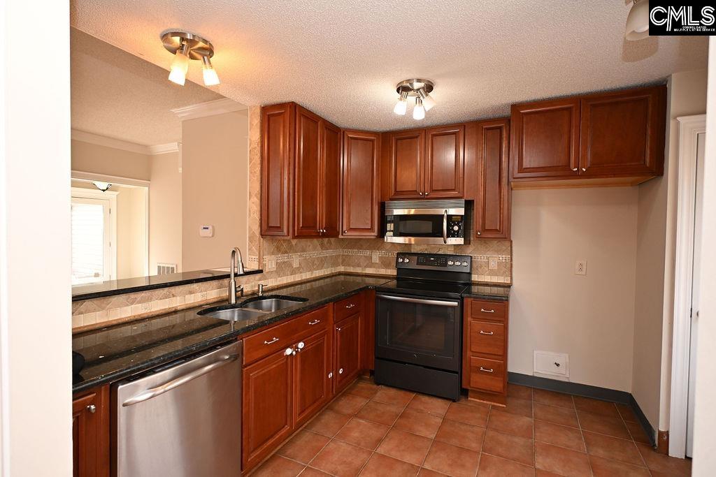 88 Running Deer Road Blythewood, SC 29016 - Photo 8 of 24 a kitchen with kitchen island granite countertop a sink stainless steel appliances and cabinets