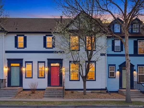 a view of a brick house with large windows