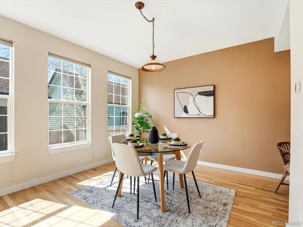 a dining room with furniture and wooden floor