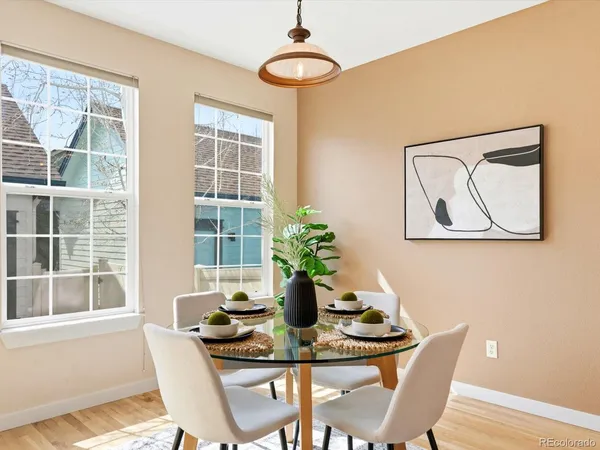 a dining room with furniture and wooden floor