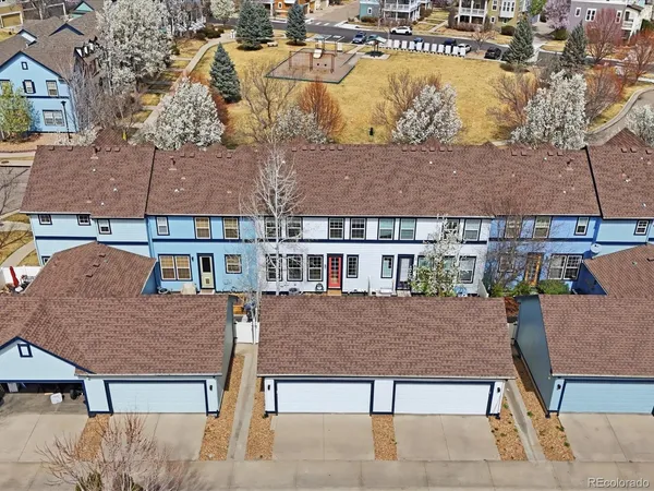 an aerial view of residential houses with outdoor space