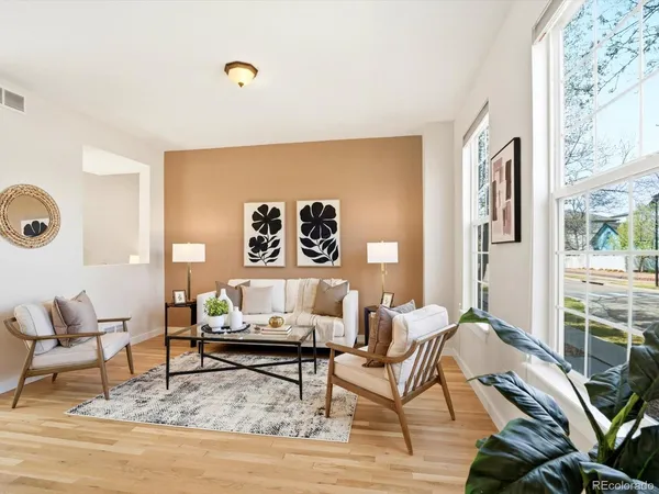 a living room with furniture and wooden floor