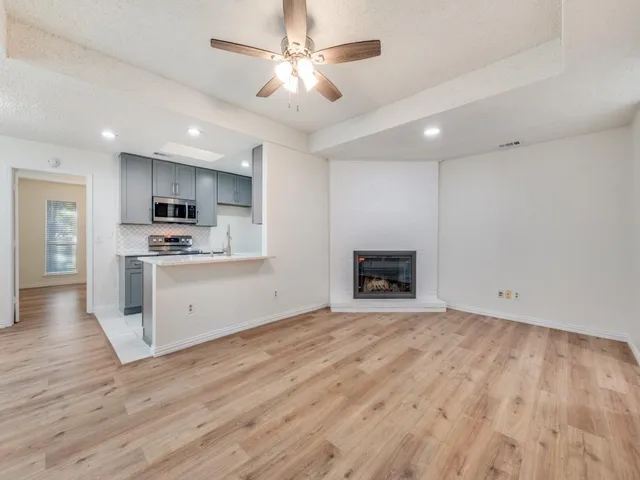 a view of a kitchen with microwave and cabinets