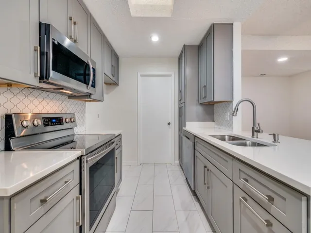 a kitchen with a sink stove and microwave