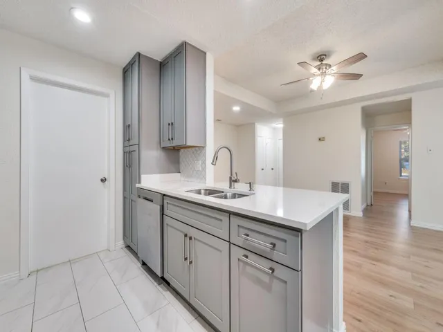 a kitchen with a sink and cabinets