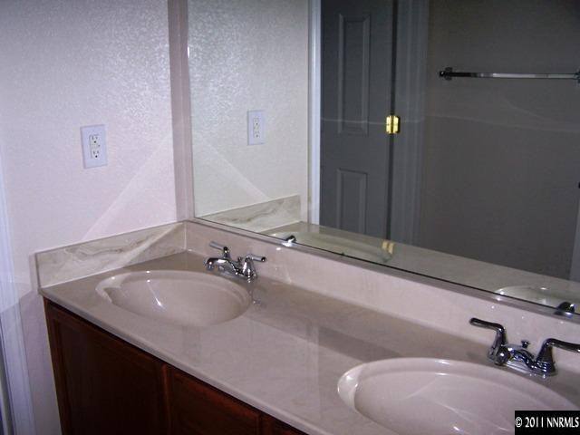 8946 Wynne Street Reno, NV 89506 - Photo 7 of 10 a bathroom with a sink and a mirror
