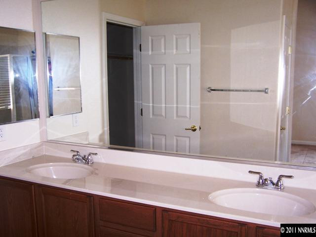 8946 Wynne Street Reno, NV 89506 - Photo 8 of 10 a bathroom with a sink and a mirror
