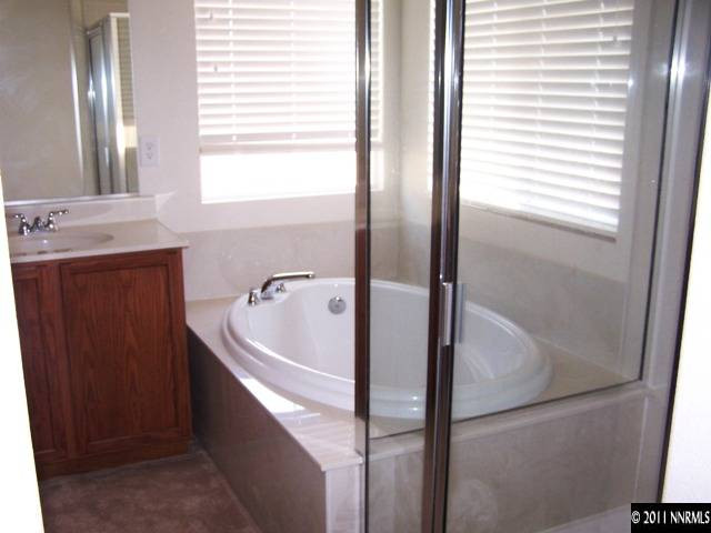 8946 Wynne Street Reno, NV 89506 - Photo 10 of 10 a bathroom with a bathtub and a sink