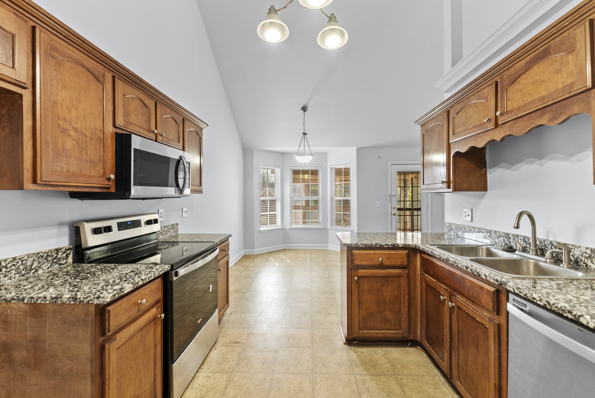 2849 Evergreen Ridge Point Nashville, TN 37217 - Photo 8 of 31 a kitchen with stainless steel appliances granite countertop a sink stove and microwave