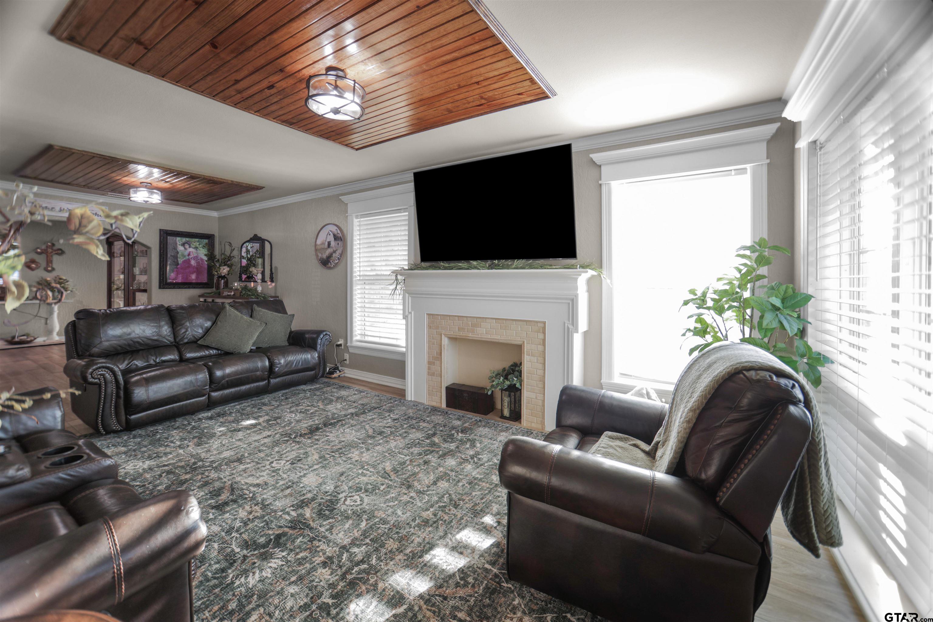 11931 State Highway 64 Tyler, TX 75704 - Photo 9 of 44 a living room with furniture a flat screen tv and a fireplace