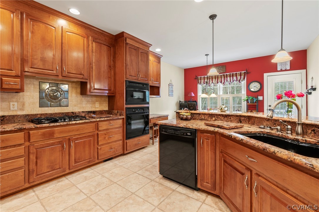 847 Club Ridge Terrace Chester, VA 23836 - Photo 13 of 35 a kitchen with stainless steel appliances granite countertop a sink a stove and a wooden cabinets
