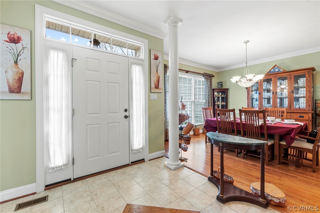 847 Club Ridge Terrace Chester, VA 23836 - Photo 3 of 35 a living room with furniture a dining table and a refrigerator