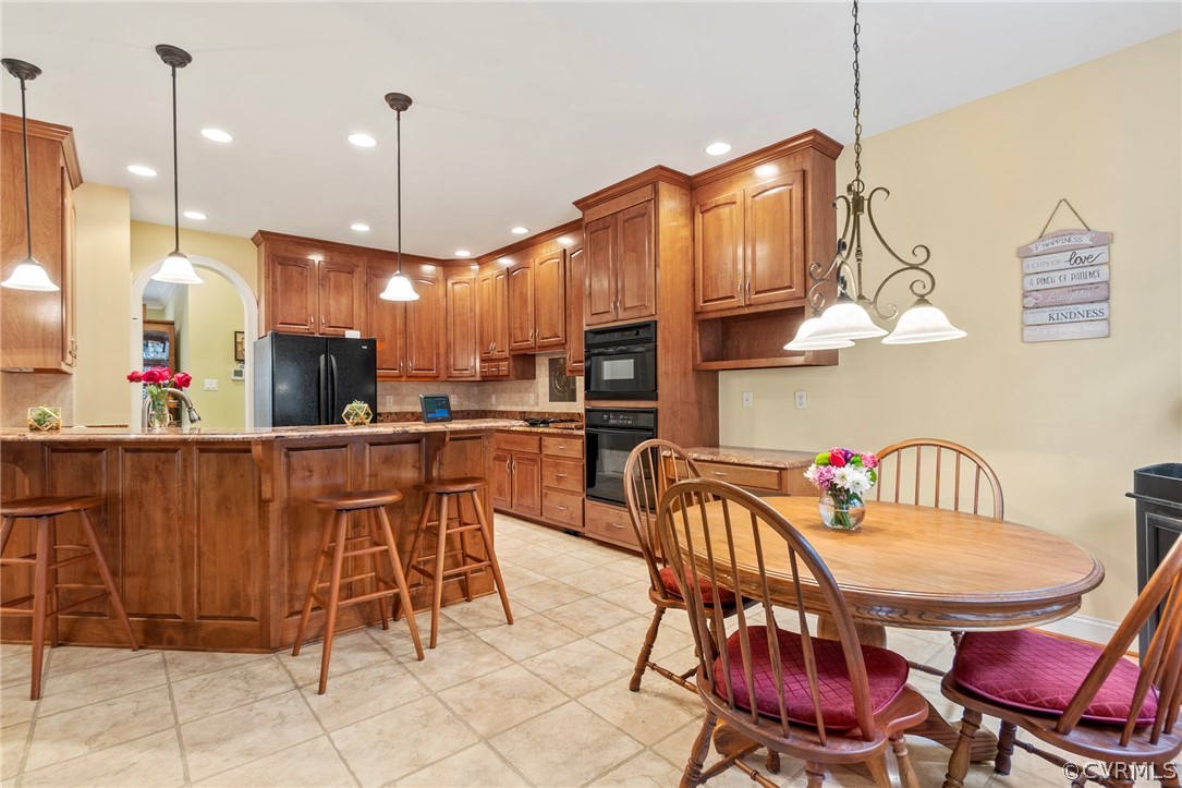 847 Club Ridge Terrace Chester, VA 23836 - Photo 10 of 35 a kitchen with stainless steel appliances granite countertop a table chairs and a refrigerator