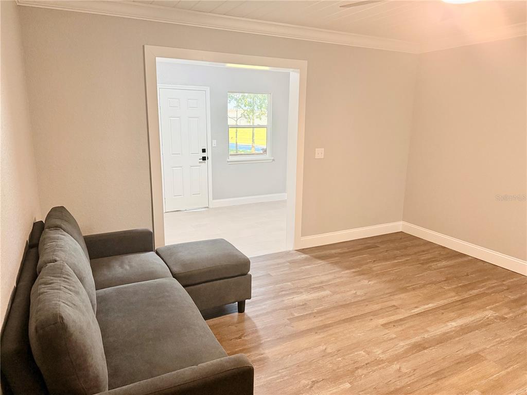 111 Water Tank Road Haines City, FL 33844 - Photo 14 of 48 a living room with furniture and a wooden floor