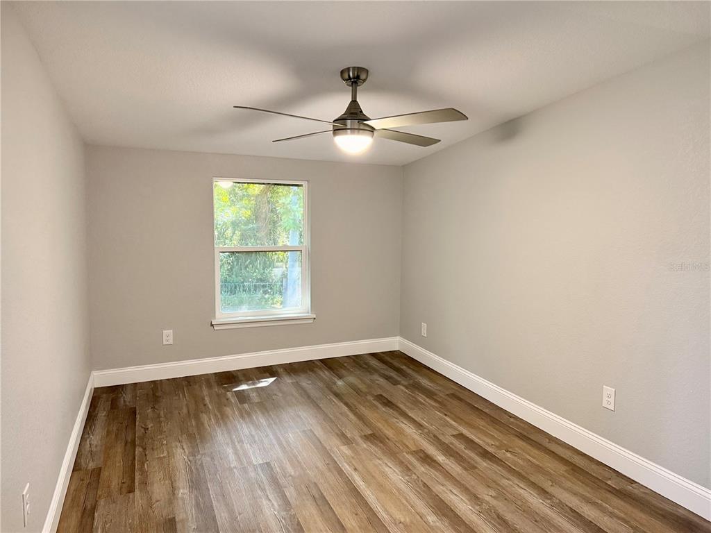 111 Water Tank Road Haines City, FL 33844 - Photo 16 of 48 wooden floor in an empty room with a window