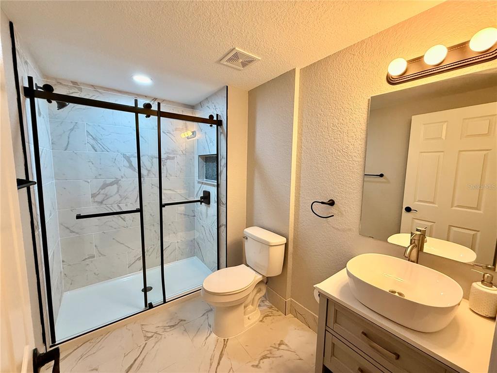 111 Water Tank Road Haines City, FL 33844 - Photo 23 of 48 a bathroom with a sink toilet and shower