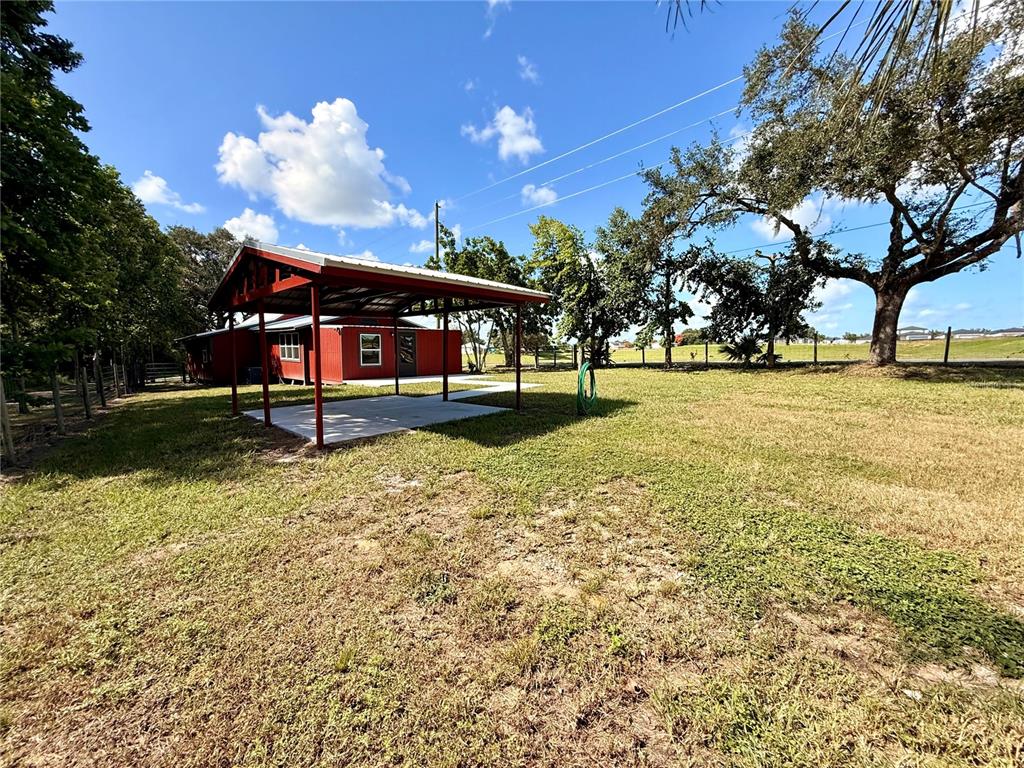 111 Water Tank Road Haines City, FL 33844 - Photo 36 of 48 a view of a swimming pool with an outdoor space and seating area