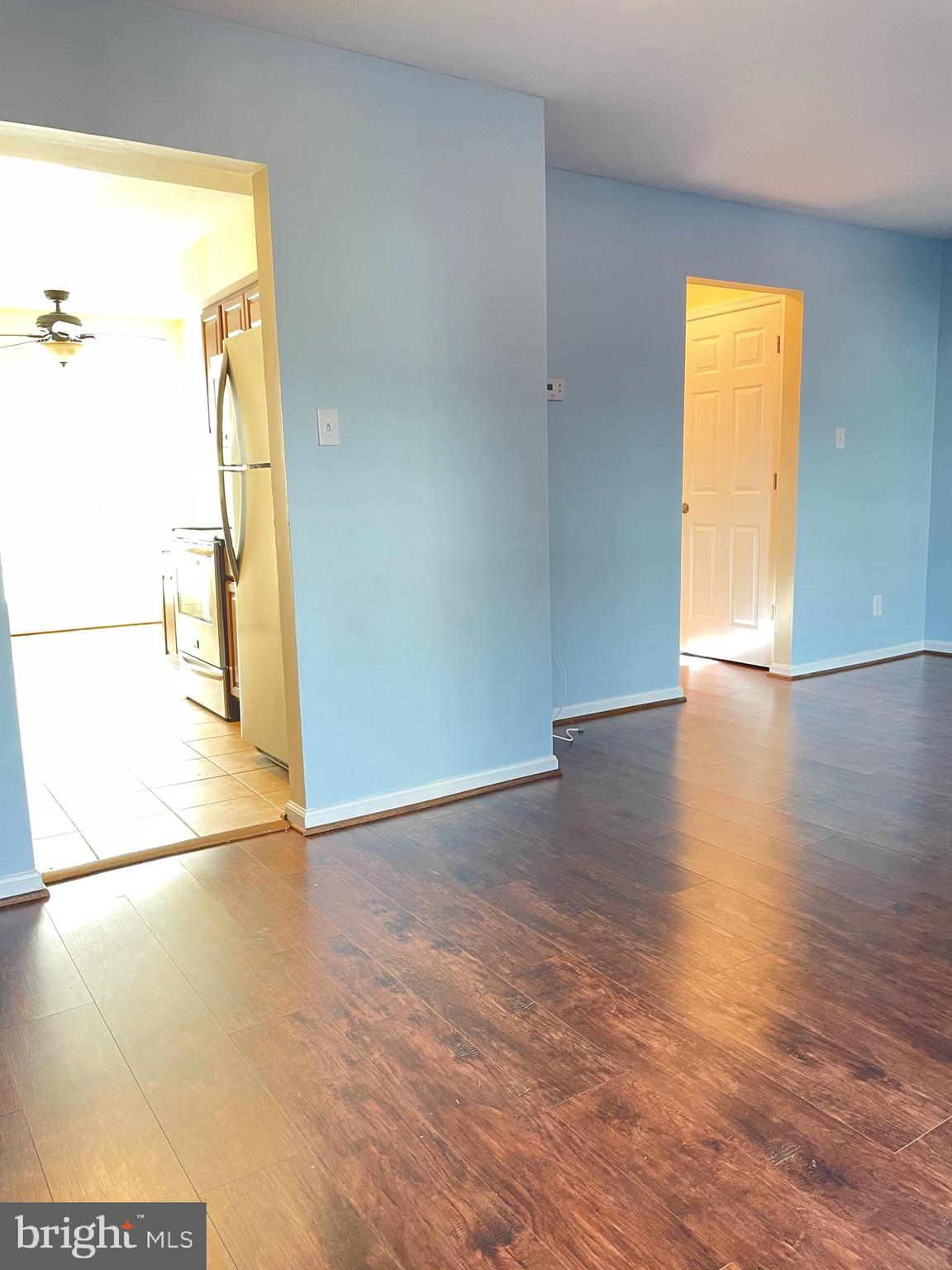 12405 Gooderham Way Gaithersburg, MD 20878 - Photo 13 of 31 a view of an empty room with wooden floor and a window