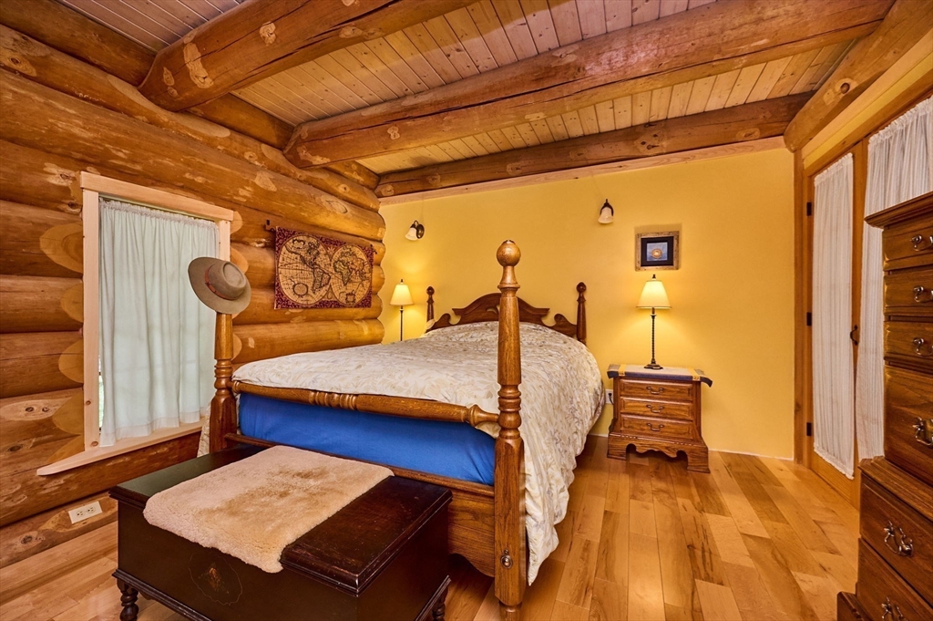 486 Old Stage Road Ashfield, MA 01330 - Photo 15 of 36 a bedroom with a bed and wooden floor