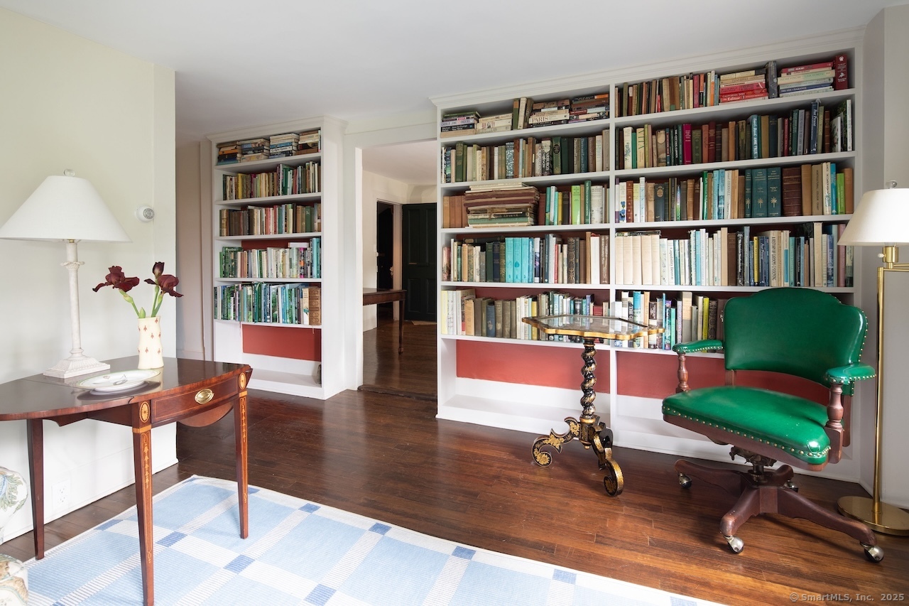 a view of a livingroom with furniture and bookshelf