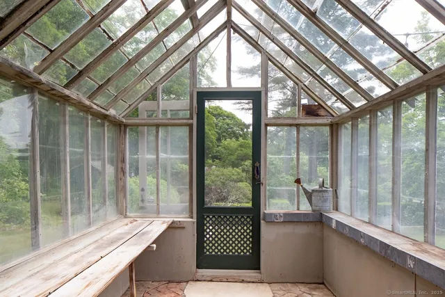 a view of a house with a yard and sitting area