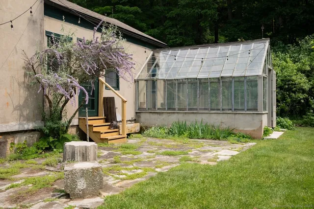 a dining room with furniture a chandelier and wooden floor