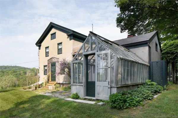 a front view of a house with a yard and a garden