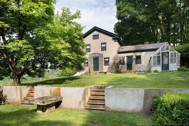 a front view of a house with a yard and a garden