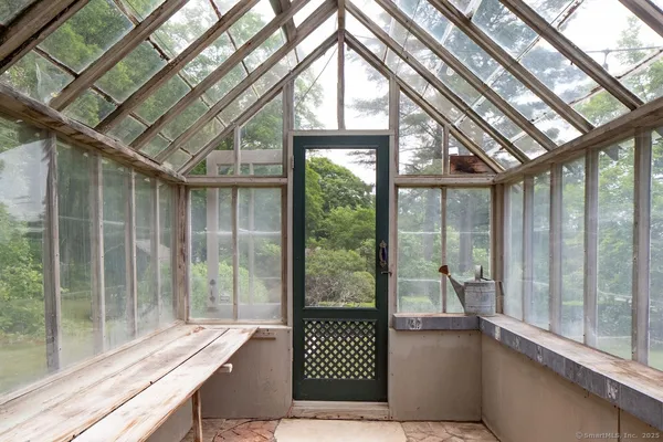 a view of a house with a yard and sitting area
