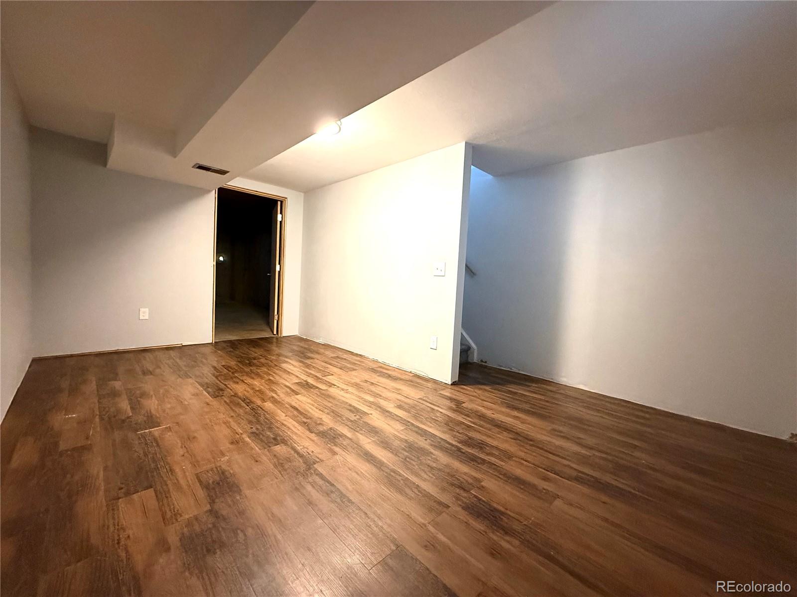 8905 Field Street, Unit 89 Broomfield, CO 80021 - Photo 16 of 18 a view of an empty room and wooden floor