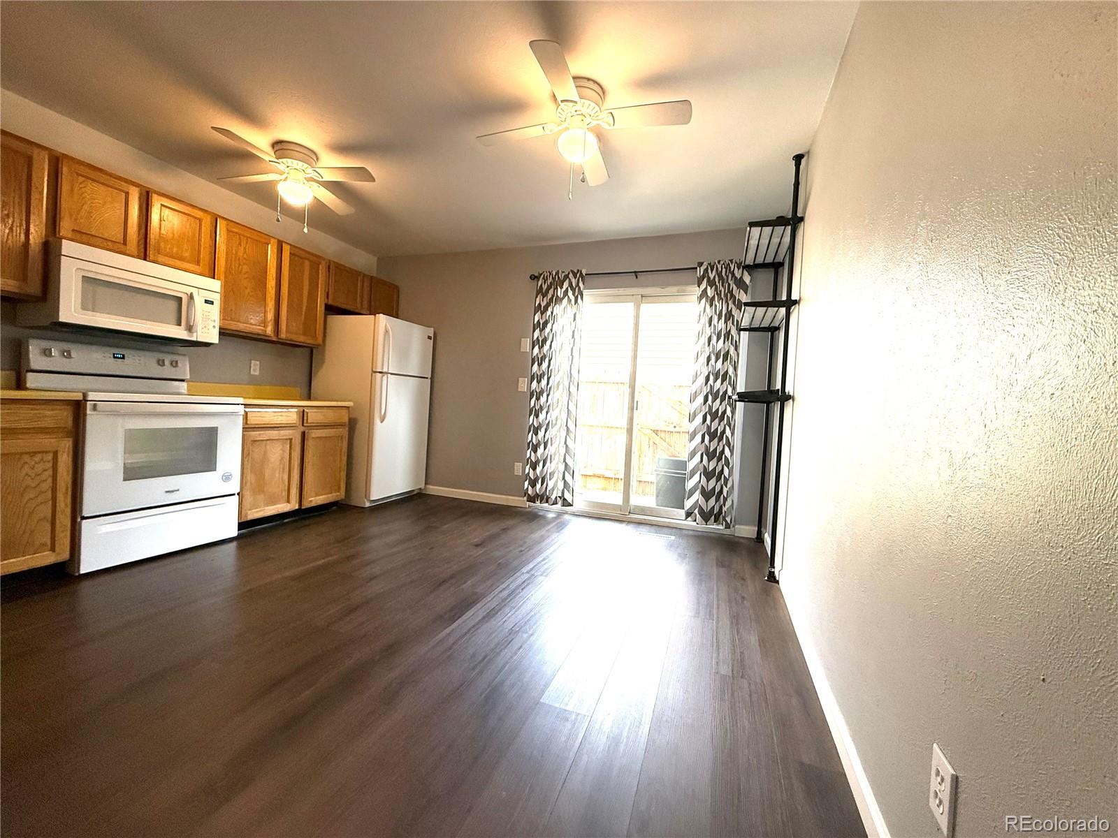 8905 Field Street, Unit 89 Broomfield, CO 80021 - Photo 4 of 18 a view of a kitchen with a stove cabinets and wooden floor
