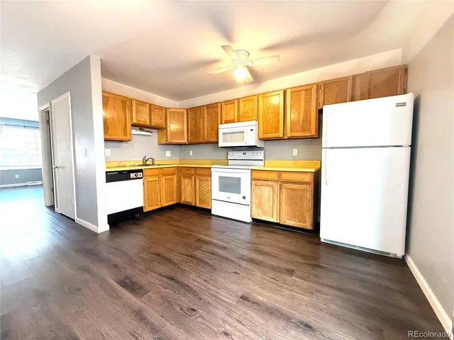 a kitchen with granite countertop white cabinets and stainless steel appliances