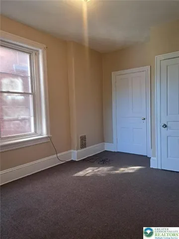 a view of an empty room with a window