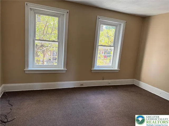 a view of an empty room with a window