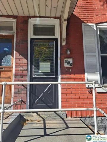 a view of a balcony with a door and a window