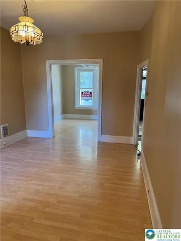 a view of a livingroom with a chandelier fan