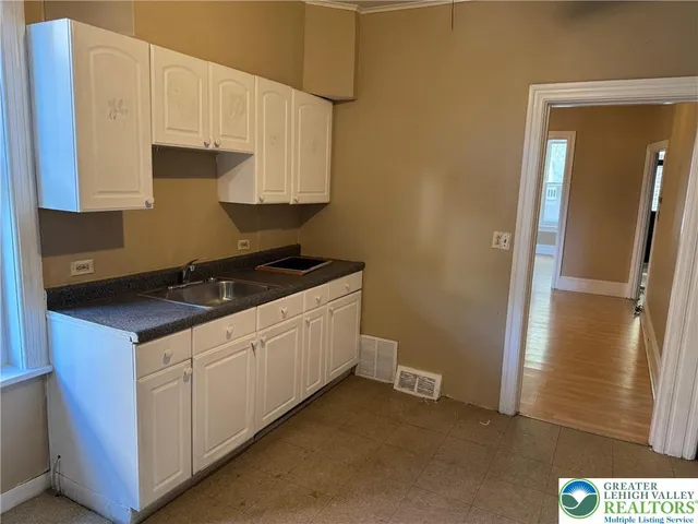a kitchen with a sink and cabinets