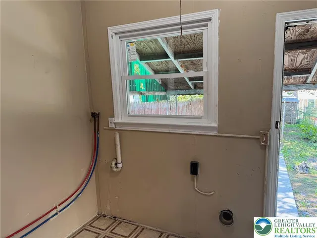 a bathroom with a shower and window