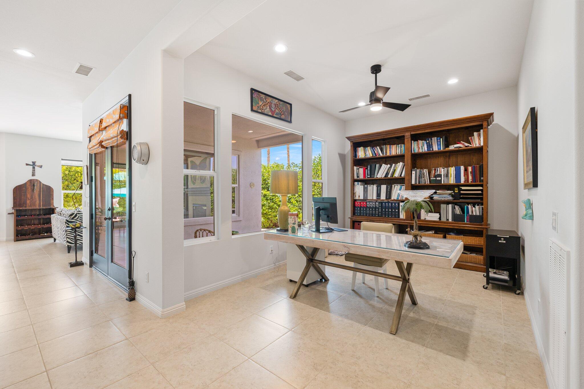 61185 Soaptree Drive La Quinta, CA 92253 - Photo 17 of 51 a work room with furniture and a book shelf