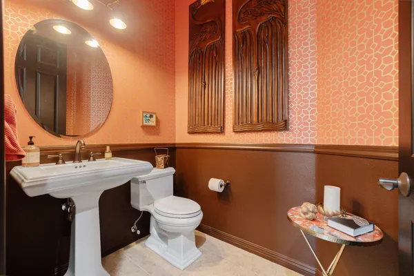 a bathroom with a toilet sink and mirror