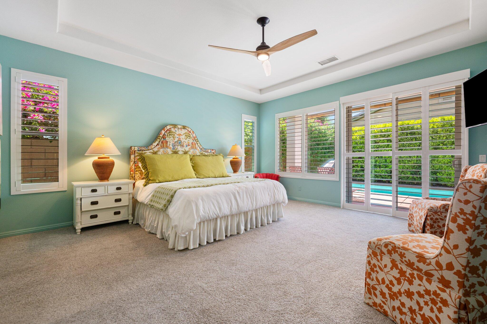 61185 Soaptree Drive La Quinta, CA 92253 - Photo 21 of 51 a spacious bedroom with a bed and a large window