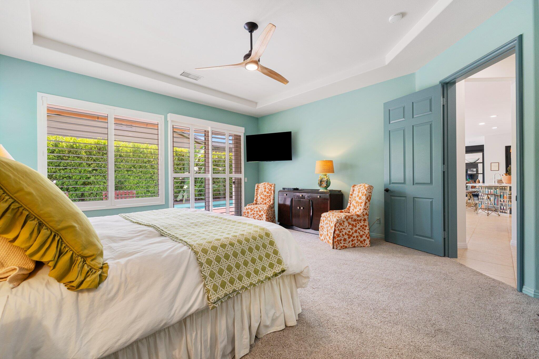 61185 Soaptree Drive La Quinta, CA 92253 - Photo 22 of 51 a spacious bedroom with a large bed and a large window