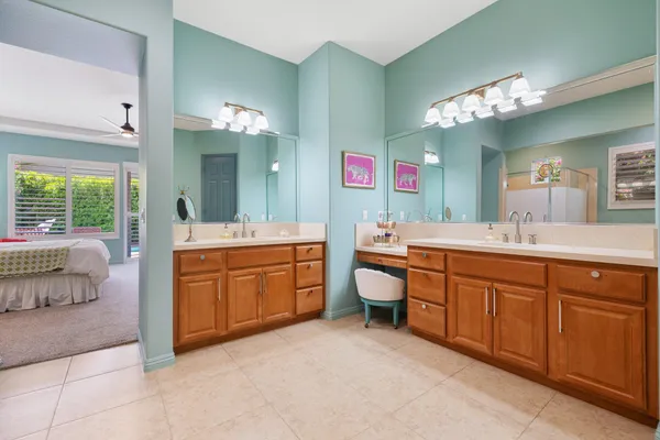 a spacious bathroom with a sink vanity granite tub and a mirror