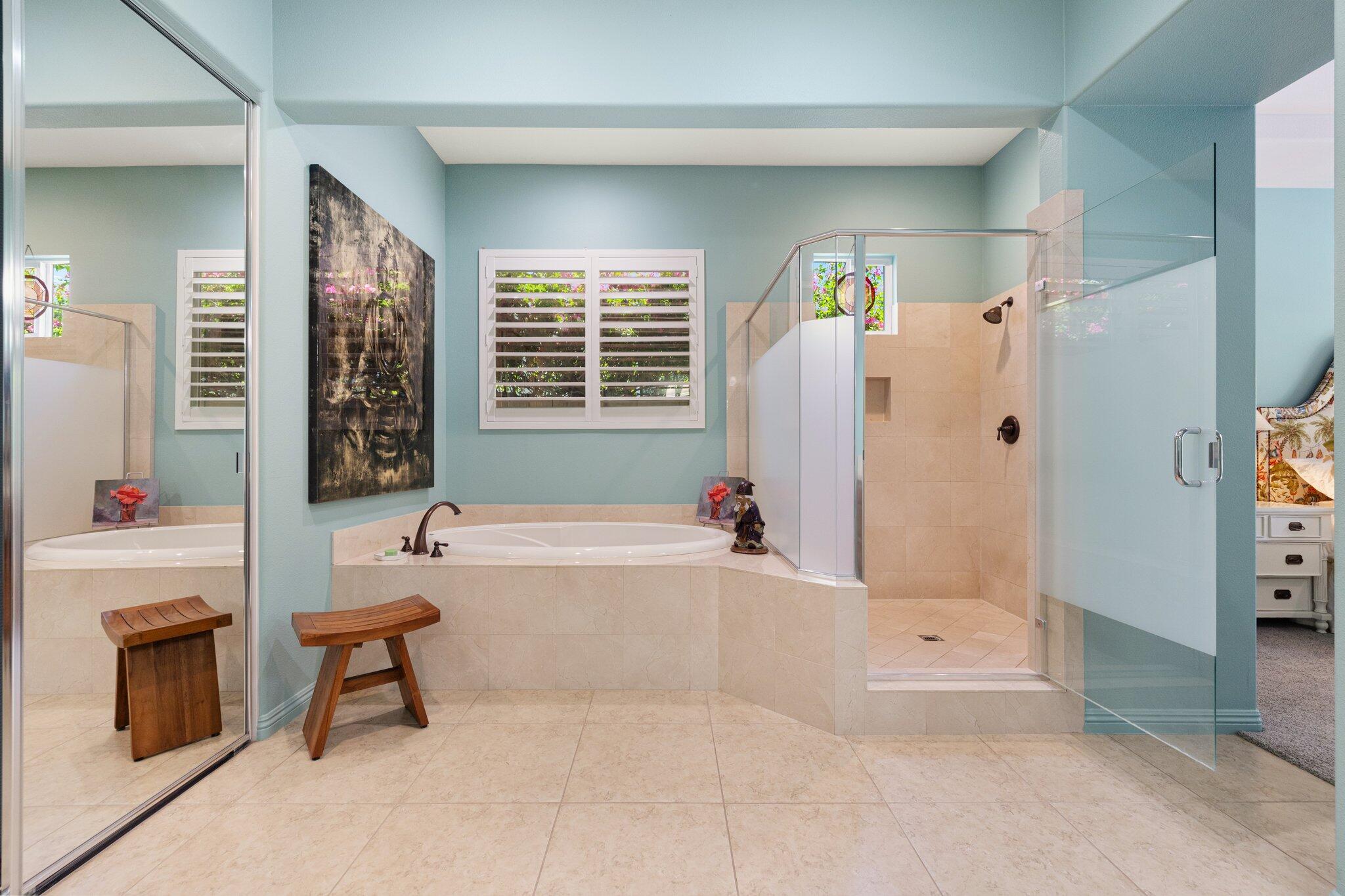 61185 Soaptree Drive La Quinta, CA 92253 - Photo 26 of 51 a bathroom with a tub a sink and a large mirror