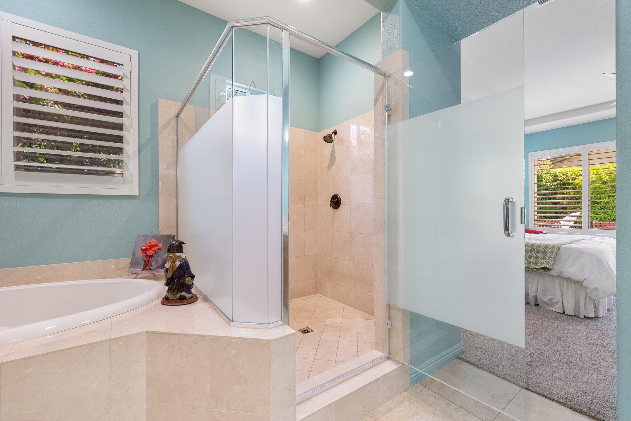 61185 Soaptree Drive La Quinta, CA 92253 - Photo 27 of 51 a bathroom with a tub shower and a sink