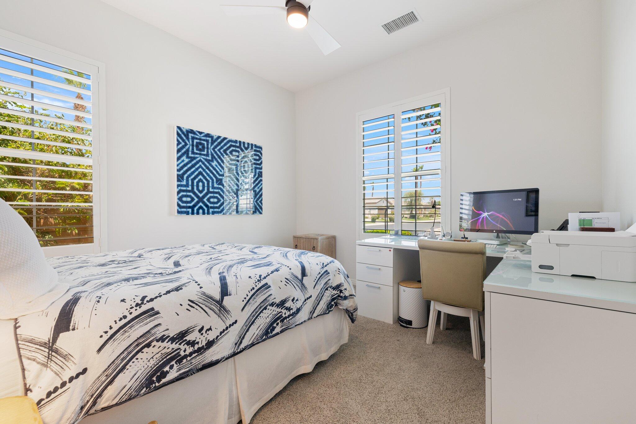61185 Soaptree Drive La Quinta, CA 92253 - Photo 28 of 51 a bedroom with a bed and a window
