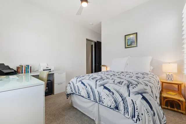 a bedroom with a bed and a table in it