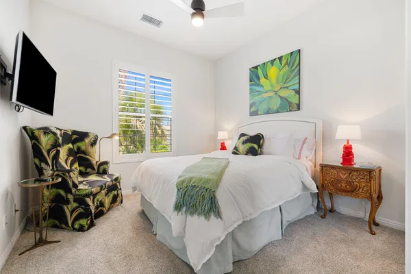 a bedroom with a bed and flat screen tv