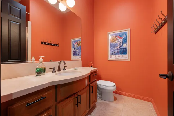 a bathroom with a toilet sink and mirror